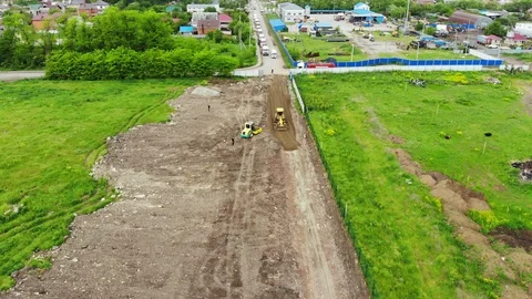 The movement of the excavator from a height. Flying over the dirt road. Stock Footage 111527821