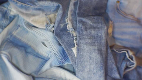 Movement of falling jeans on a pile of denim pants. Stock Footage 101479349