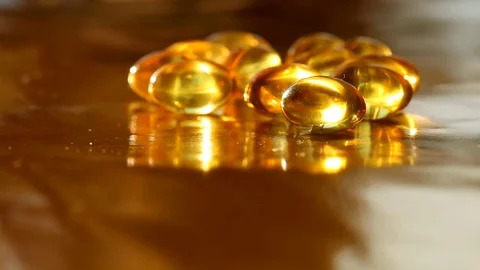 The movement of fish oil capsules Stock Footage 72032629