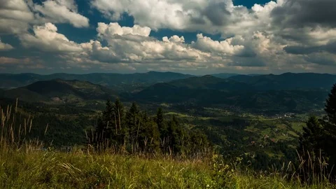 Movement of fluffy clouds over the mountains, shadows on the mountains 動画素材 73924428