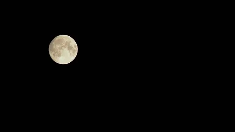 Movement of the full moon at night across the dark sky Stock Footage 156238573