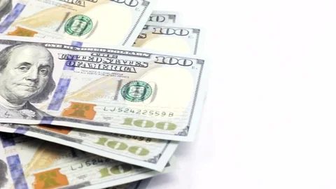 The movement of hundred dollar bills in the frame on white background Stock Footage