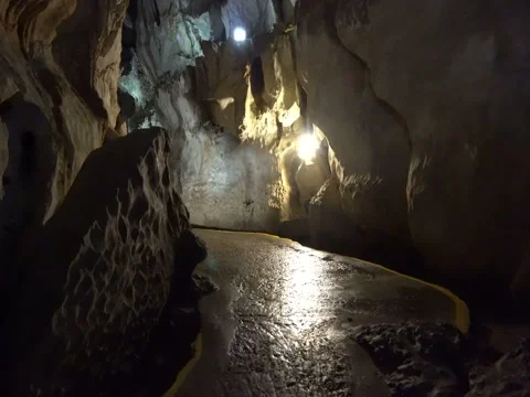 Movement inside the underground cave with overhanging rocks in a dark Video stock 71423723