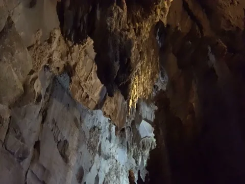 Movement inside the underground cave with overhanging stalactites and sta Stock Footage 71423742