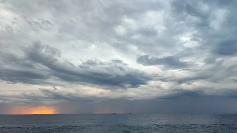 Movement large gray rain clouds, falling rain, yellow-orange spot of rising sun Stock Footage 212937214