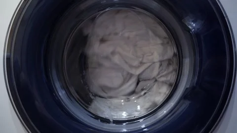 The movement of laundry when drying in the washing machine. Wet things in the Stock-Footage 246823847