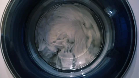 The movement of laundry when drying in the washing machine. Wet things in the Stock Footage 249177313