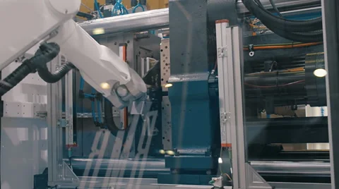 Movement molds, robot arm manipulator takes the finished product and stock them Stock Footage 61549664