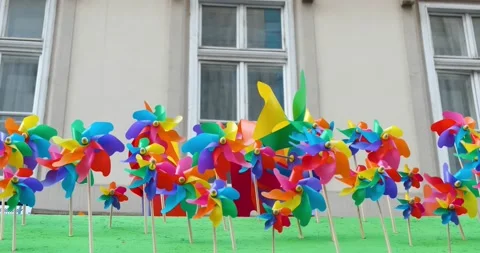 Movement of multicolor windmills. Abstract symbol concept of diversity or Stock Footage 132456423