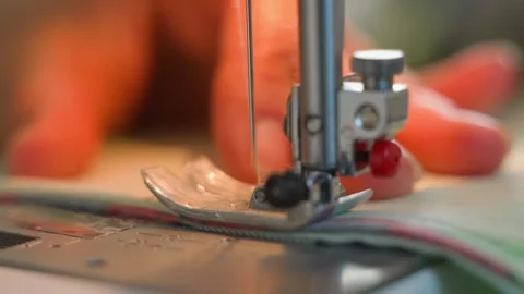 The movement of the needle when sewing with a sewing machine, close-up. Sewing Stock Footage 253170971