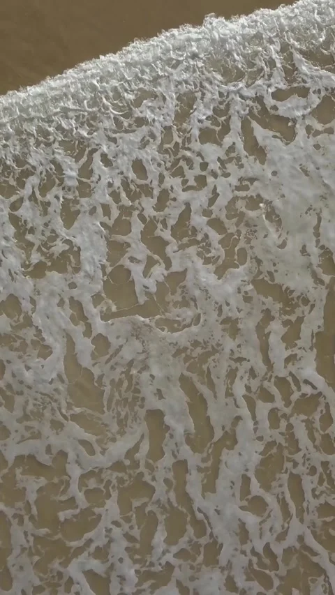 Movement of ocean waves seen from above by drone. Vertical video Stock Footage 281661022