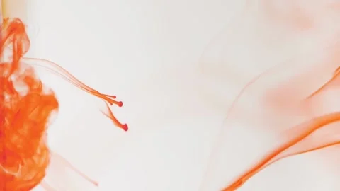 Movement of orange ink drops paint in water. Close-up ink in water. Close-up sho Stock Footage 131379736
