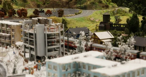 Movement of a passenger train between the city under construction and the Stock Footage 102480883