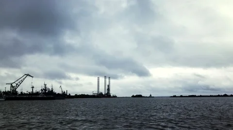 The movement of rain clouds over the sea port Stock-Footage 64878332