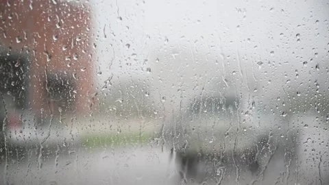 Movement of Rain falling on car windshield,drive car on street in city at heavy Stockbeeldmateriaal 136378749