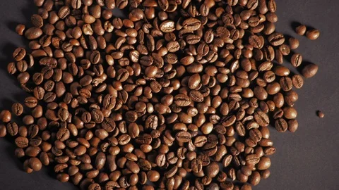 Movement, Roasted Coffee Beans Lie on the Table Stock Footage 99121399