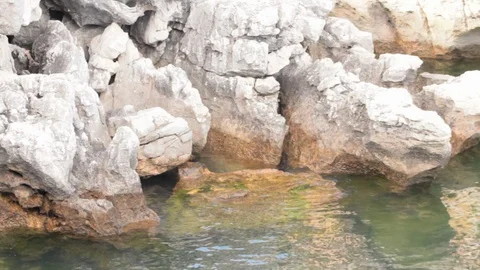 Movement of the sea water in the shore on the rocks Stock Footage 90796053