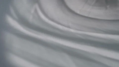 The movement of shadows from curtains on a white background. Defocusing. Bokeh. Stock Footage 157832425