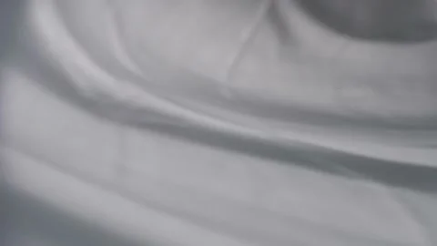 The movement of shadows from curtains on a white background. Defocusing. Bokeh. Stock Footage 157881094