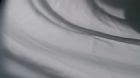 The movement of shadows from curtains on a white background. Defocusing. Bokeh. Stock Footage 157981825