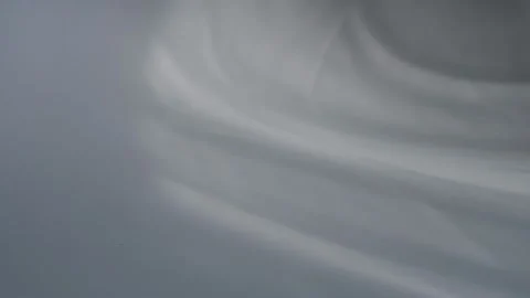 The movement of shadows from curtains on a white background. Defocusing. Bokeh. Stock Footage 158016627