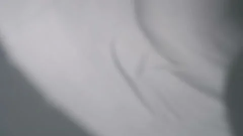 The movement of the shadows from the curtains on a white background. Video stock 159718539
