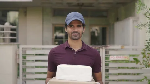A movement shot of a delivery guy holding a parcel  in his hands 스톡 동영상 147340505