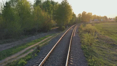 .Movement on a single-track railway in the rays of the setting sun Stock Footage 107687272