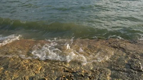 The movement of small waves crashing against the edge of the lake Stock Footage 291523624