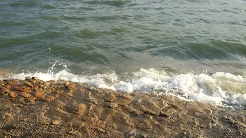 The movement of small waves crashing against the edge of the lake Stock Footage 291523637