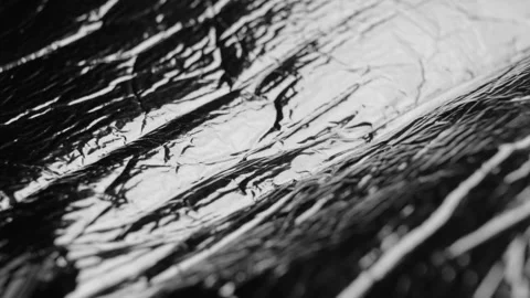 Movement of soft packaging wrapping shiny plastic foil Stock Footage 248925582