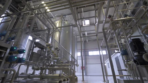 Movement through the factory interior between metal tanks and pipes. Stock Footage 168581787