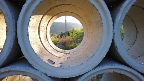 Movement through a gray concrete pipe. Power transmission tower. Stock Footage 137959324