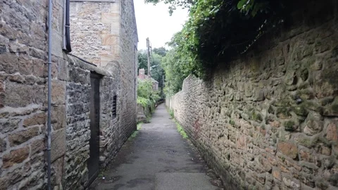 Movement Through a Narrow Passage Between Old Stone Walls Stock Footage 249083541