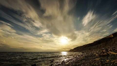 The movement of thunderclouds over the sea on the beach Stock Footage 128743631