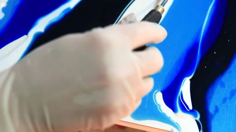 Movement tool in liquid epoxy. To create pattern surface using liquid dyes. Stock Footage 145158248