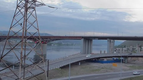 The movement of the train on the bridge over the river at sunset in summer day Stock Footage 77916024