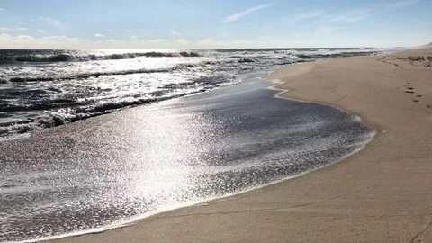 The movement of the waves on a beach are curves and frequent Stock Footage 83057822