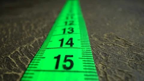 The movement of white measuring tape. Macro shot of tape-line. Centimeters in Stock Footage 241304530