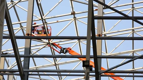 Movement of workers at a height in the lift between the structures of metal Stock Footage 74003806