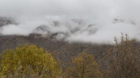 The movements of clouds up to the slopes of the mountains of Caucasus peaks. Stock Footage 70152548