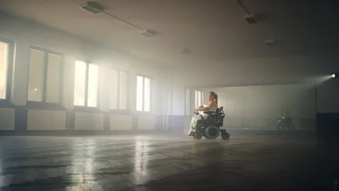 Movements of a woman with a disability in a dance performance in a wheelchair Video stock 290328488