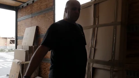 Mover Worker Setting Aside Box Inside Truck Handheld Shot Stock Footage 129499608
