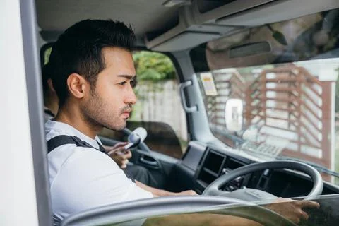 Mover workers driving truck for relocation service. Diversity in ethnicity Stock Photos