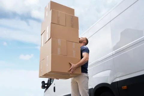 Movers Carrying Heavy Large Box Stack Stock Photos