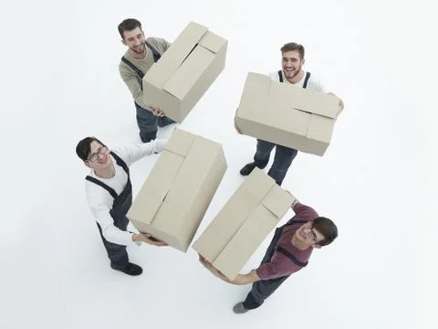 Movers lifting stack of cardboard moving boxes isolated on white Stock Photos