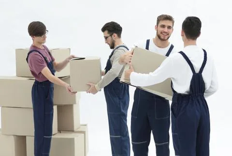 Movers lifting stack of cardboard moving boxes isolated on white Stock Photos