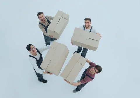 Movers lifting stack of cardboard moving boxes isolated on white Foto stock
