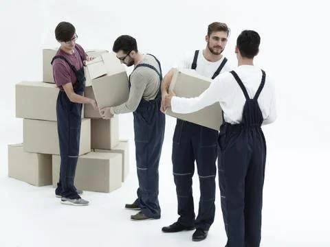 Movers lifting stack of cardboard moving boxes isolated on white Foto stock