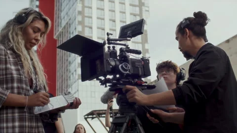 Movie Crew Preparing Camera for Shoot on Outdoor Film Set Stock Footage 336699873